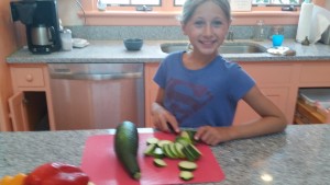 Ali chopping zucchini from our garden