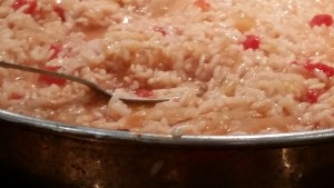 Rice, onions, garlic, saffron and tomato simmering