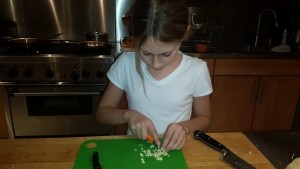 Alex chopping garlic for chicken