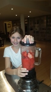 Making strawberry daquiris with fresh and frozen strawberries.